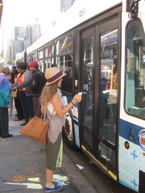 A line of people waited to pay their fare as the bus pulled away. Photo: Noah Kazis.