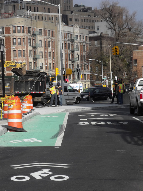 Sharrows lead cyclists across St. Nicholas traffic and over an island that sends motor traffic onto Amsterdam Ave. Photo: BicyclesOnly via Flickr.