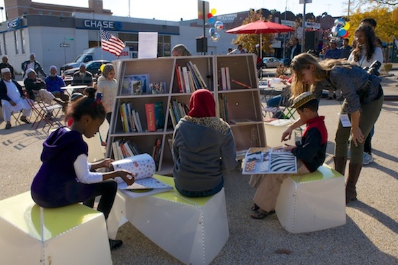 Ozone Park children read at The Uni portable library during the November 2 grand opening. Photo: DOT/The Unit