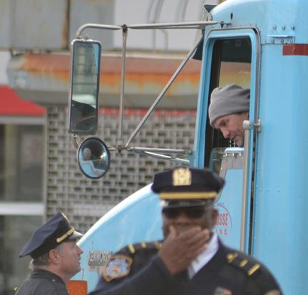 Police speak with Mauricio Osorio-Palaminos, the truck's driver, this morning. Photo: News