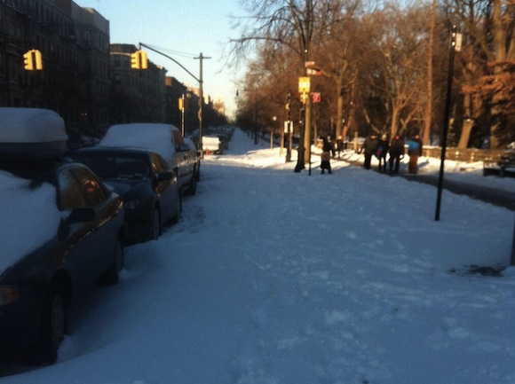 While some protected bike lanes have been cleared, the Prospect Park West bike lane remains covered in snow. Photo: Alex Knight/Twitter