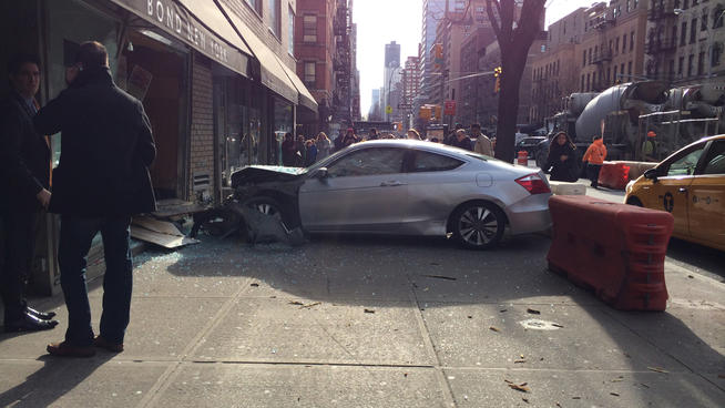 A driver jumped a curb on the Upper East Side, crashing into a storefront and injuring two passengers. No charges were filed. Photo: ##http://www.nbcnewyork.com/news/local/Upper-East-Side-Car-Crash-Window-Storefront-Second-Avenue-241185961.html##WNBC##