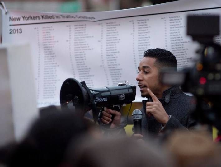 Council Member Antonio Reynoso speaks before a banner listing the names of New Yorkers killed in traffic violence since the start of last year. Photo: Anna Zivarts