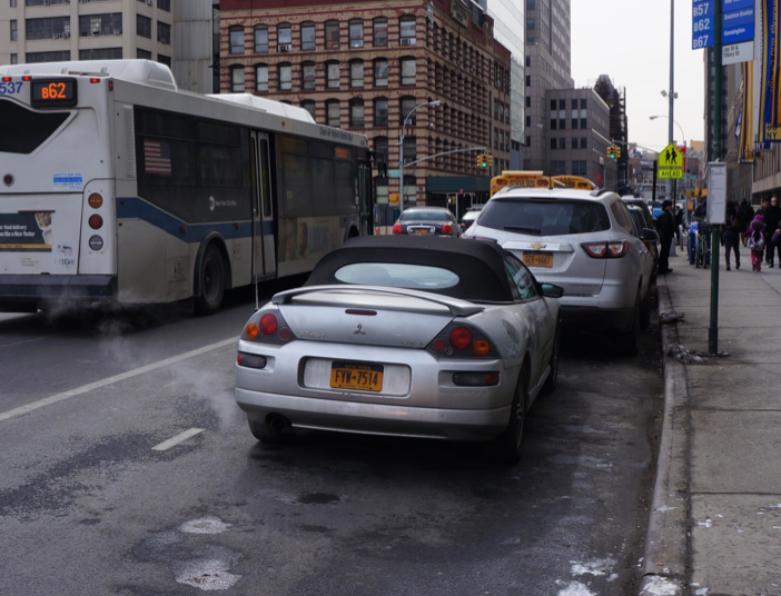 In addition to longer-term design changes, improving Jay Street could start with better enforcement against illegal parking in bus stops and bike lanes. Photo: Street Plans Collaborative