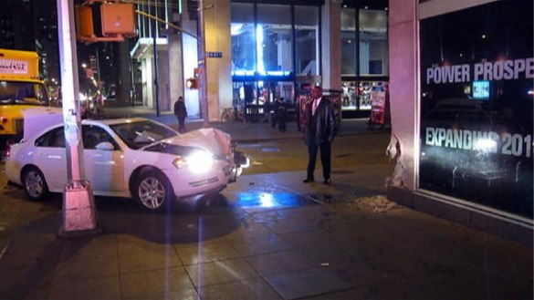 A motorist drove onto the sidewalk and hit the News Corp. building in Midtown. Five people were injured, two seriously. Photo: WNBC