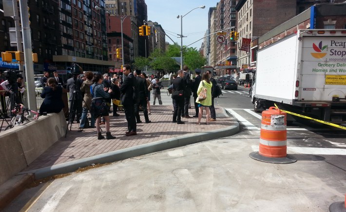 Press gathers this morning on an expanded pedestrian island at 96th Street and Broadway that, until recently, had been a left turn lane. Photo: Stephen Miller