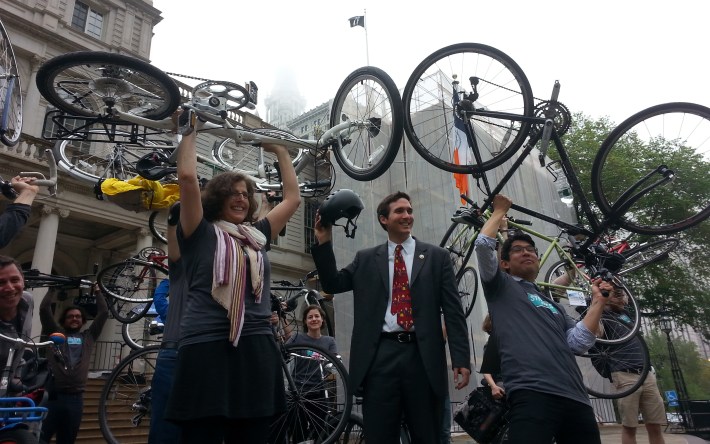 Council Members Helen Rosenthal, Ben Kallos, and Carlos Menchaca raise their bicycles outside outside of City Hall this morning. Photo: Stephen Miller