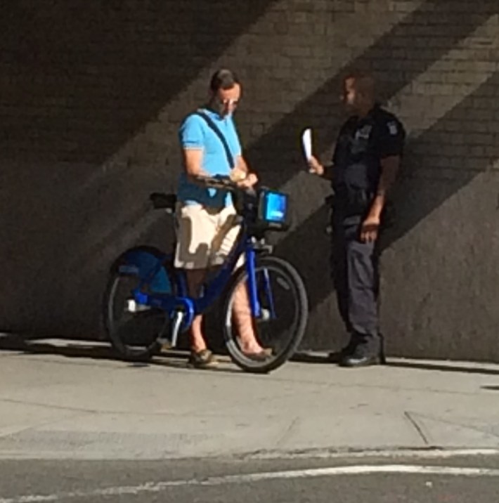 A reader photo of NYPD issuing tickets on Houston Street today.