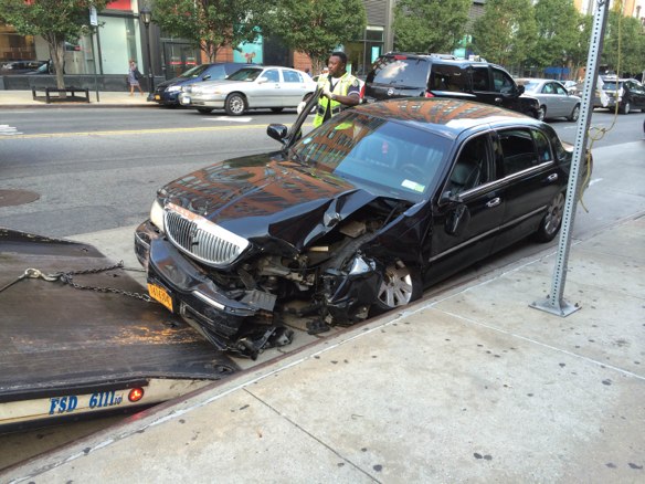 A livery cab driver jumped the curb on Atlantic Avenue after colliding with the driver of a flatbed truck, striking a pedestrian on the sidewalk and crushing her leg. The truck driver was summonsed for an improper turn and other violations, according to the TLC. The cab driver was not ticketed or charged. Photo: Sarah Goodyear