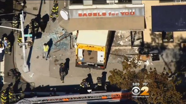 A motorist drove a truck through a bagel shop on Queens Boulevard in Forest Hills, injuring five people inside, including an infant. NYPD: "No criminality suspected." Image: CBS 2