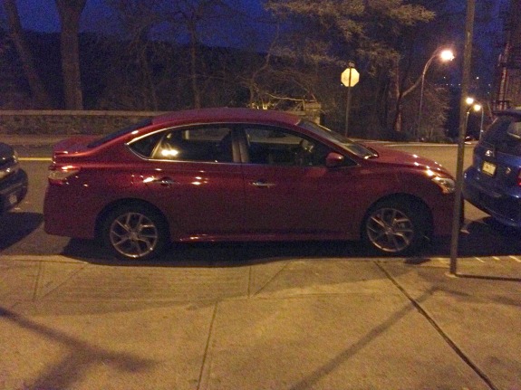 The DOT disability parking permit on the dashboard expired weeks ago, but this driver continues to park in a no parking zone, blocking the curb ramp. Photo: Brad Aaron