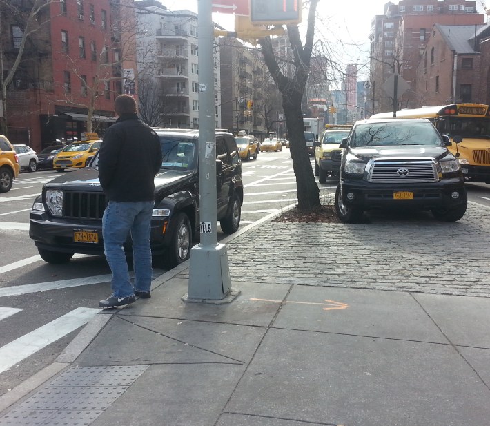 Not everything is fixed at the intersection. Fire Department employees continue to abuse pedestrian space for personal parking. Photo: Stephen Miller