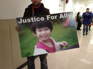 Volunteers displayed posters outside the DMV hearing room.