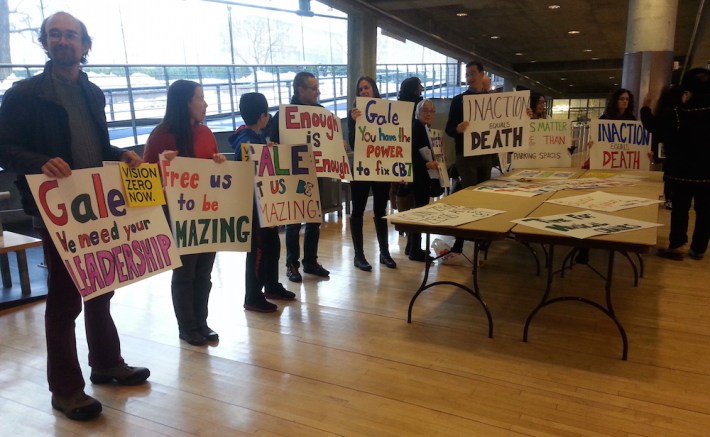 Traffic safety advocates and families of traffic violence victims line the entrance to Brewer's speech. Photo: Stephen Miller