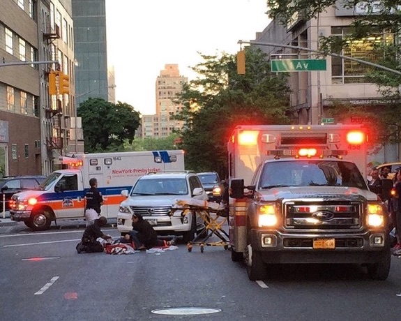Paramedics work to save John Torson a few feet from the crosswalk at E. 61st Street and First Avenue. Photo: Daniel S. Dunnam