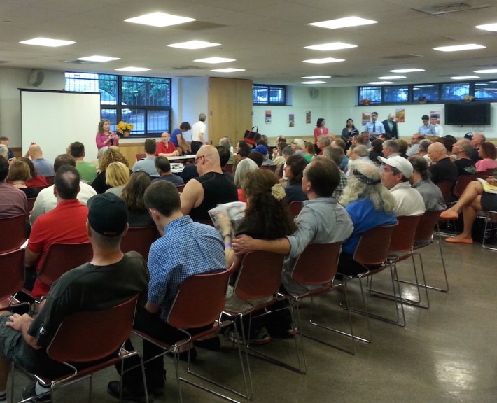 CB 7 chair Elizabeth Caputo addresses nearly 200 people waiting to learn more about Citi Bike station locations last night. Photo: Stephen Miller