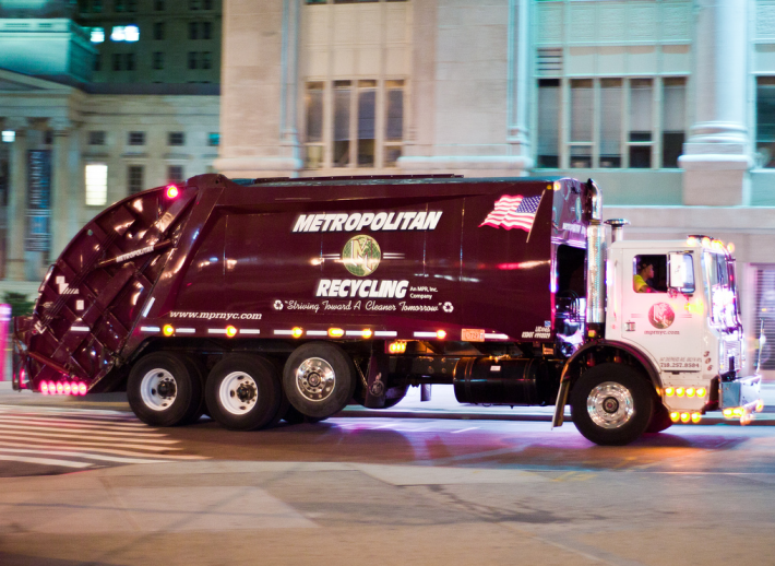 Under a City Council bill likely to pass tomorrow, city-owned and private trash trucks would be required to have side guards to protect fallen pedestrians and cyclists. Photo: Douglas Palmer/Flickr