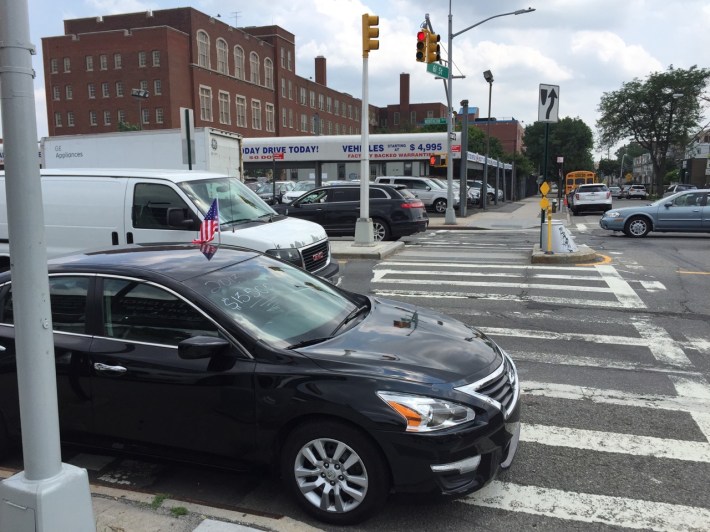 The crosswalk where 8-year-old Noshat Nahian was killed is blocked by a car dealership using it as a display space for its latest models. Photo: Clarence Eckerson Jr.