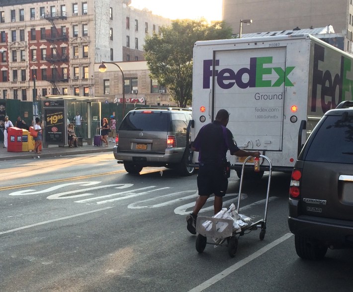 FedEx likely isn't paying a dime for double parking. Photo: Stephen Miller