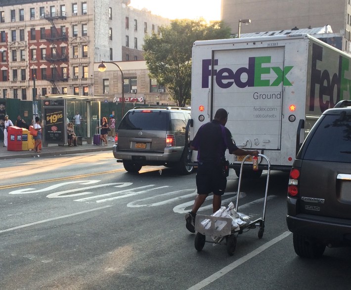 FedEx likely isn't paying a dime for double parking. Photo: Stephen Miller