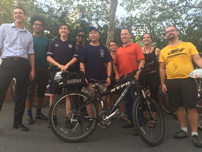 Traffic safety advocates pose with members of the Fifth Precinct before yesterday's bike ride. Photo: Stephen Miller