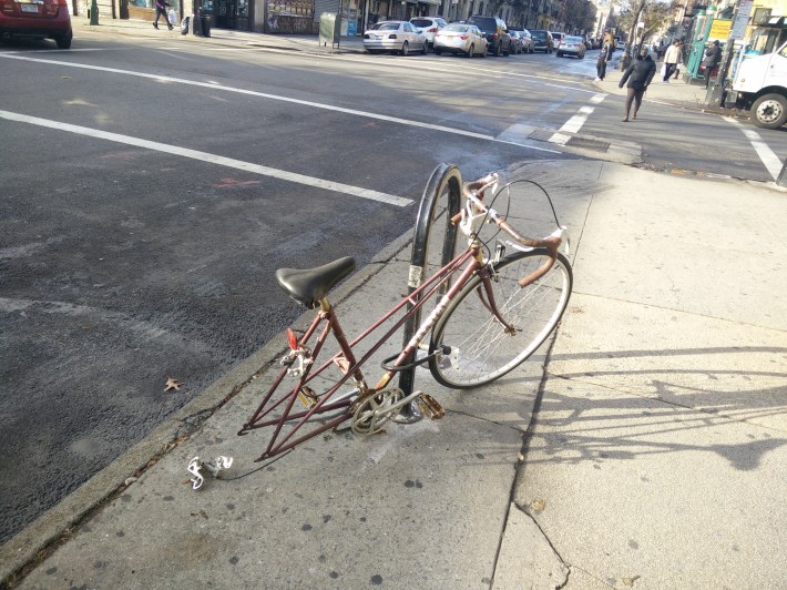 This abandoned bike on Nostrand does not meet the city's current criteria for removal. Photo: David Meyer