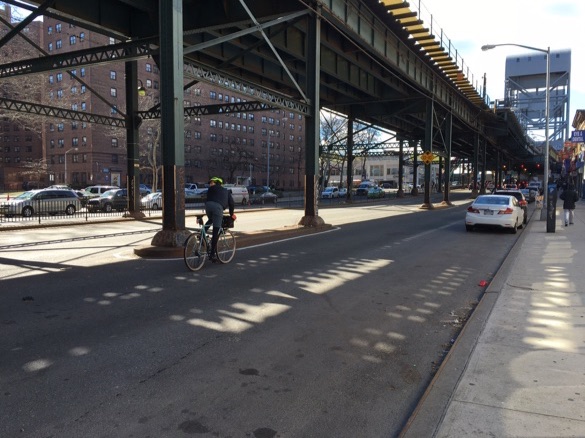There is no bike infrastructure on Broadway, but there are pedestrian fences. Broadway Bridge in the background.