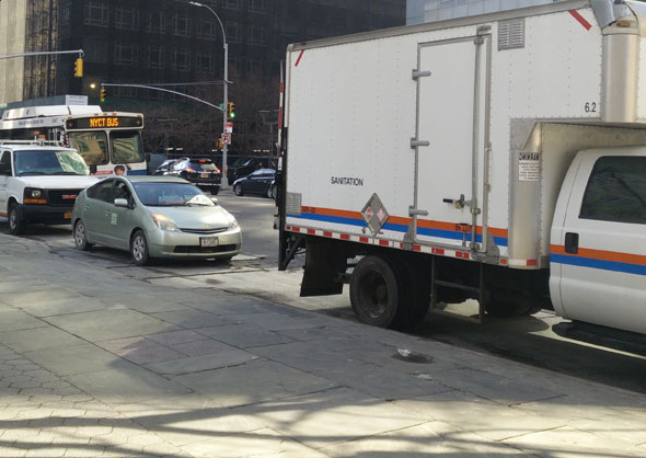 Illegally parked vehicles, including a DOT car, in a Jay Street bus stop. Photo: David Meyer