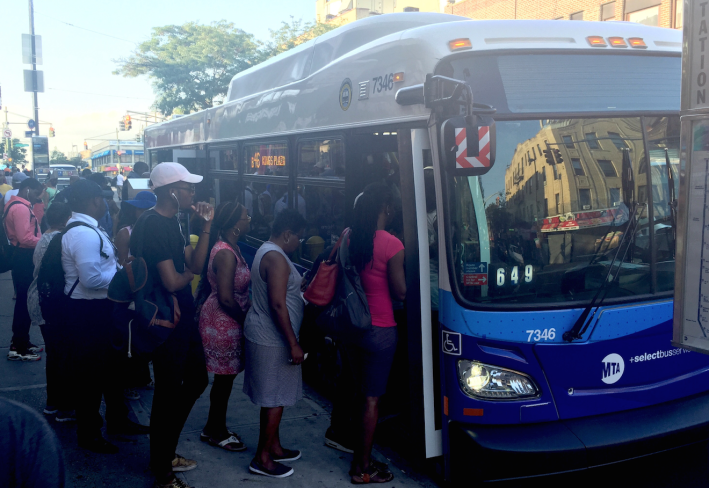 Riders board the B46 SBS at the bus stop where the route connects to the 3 and 4 trains. Photo: David Meyer