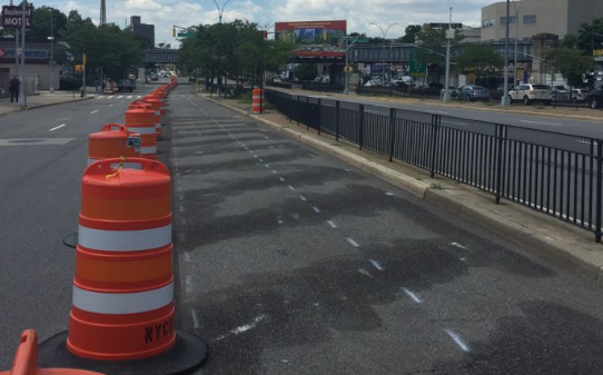 DOT has begun building out phase 2 of its safety improvements on Queens Boulevard, which include a protected bike lane. Photo: Jaime Moncayo
