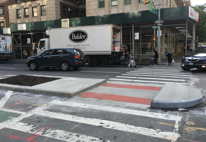 Pedestrian islands, like this one at 73rd Street and Amsterdam Avenue, shorten crossing distances while providing additional protection for cyclists. Image: Robert Baron