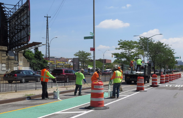 DOT crews installing the new protected bike lane earlier this month at Kneeland Street. Photo: DOT