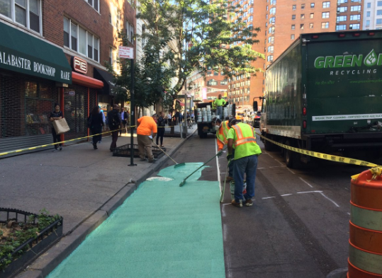 DOT crews installing a new protected bike lane on 4th Avenue between 12th and 13th Streets earlier this week. Photo: NYC DOT