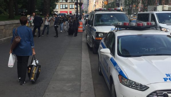 These NYPD vehicles are already parked in a bike lane. Let's hope they're gone when that lane gets protected in the coming weeks. Photo: David Meyer