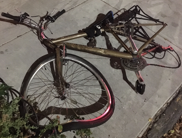 If, as NYPD says, the cyclist collided with vehicle head-on, why is the rear tired destroyed? Photo: Toby Cecchini