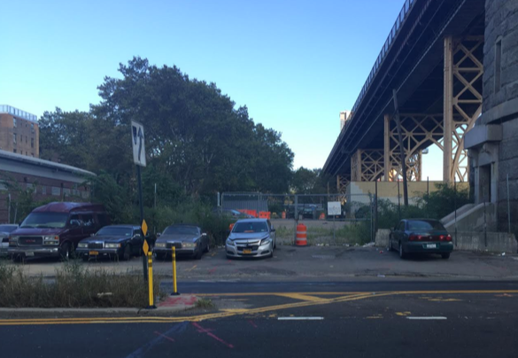 Vernon Boulevard, with Queensboro Bridge at right, is lined with illegally-parked cars, some of them apparently abandoned. Photo: David Meyer