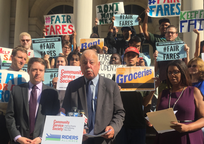 Community Service Society President David Jones (podium) speaking this morning alongside Rider Alliance Executive Direction John Raskin (left) and Public Advocate Letitia James. Photo: David Meyer