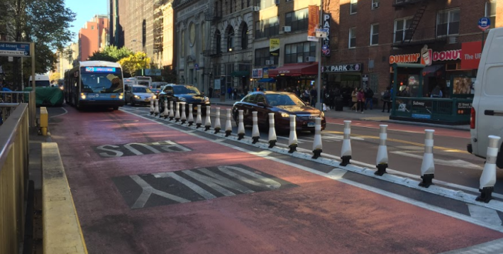 "Flexible bollards" at Sixth Avenue aim to keep motorists out of buses way. Photo: David Meyer