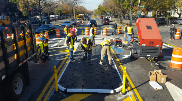 DOT crews began installing removable plastic pedestrian islands on Eastern Parkway yesterday. Photo: DOT