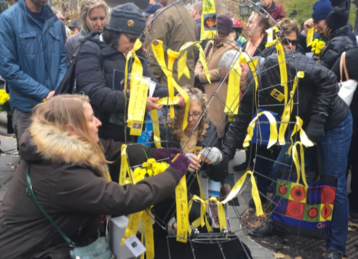 Families attached yellow ribbons to a "zero" statue. Photo: David Meyer
