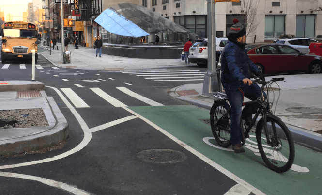 A cyclist passes by the 94th Street entrance to the soon-to-open Second Avenue Subway. Photos: David Meyer