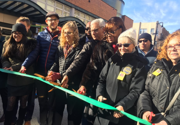 Judy Kottick, third from left, cuts the ribbon on the new plaza.