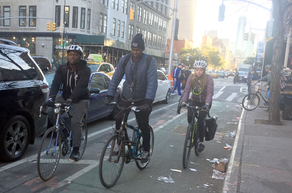 The Sixth Avenue protected bike lane is a huge improvement. Now it needs to extend all the way to Central Park. Photo: David Meyer