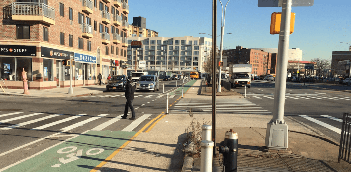 The expanded pedestrian space, bike lane, and new mall-to-mall crosswalk at Queens Boulevard and Van Loon Street. Photo: David Meyer