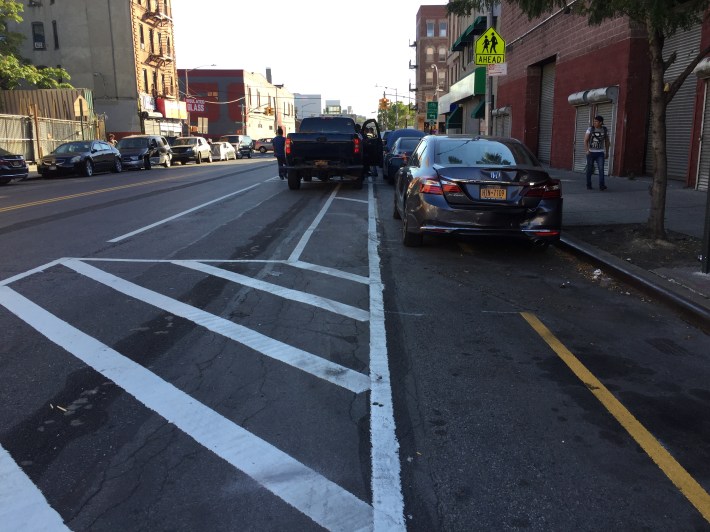The bike lane on St. Ann's Avenue between the Bruckner Expressway and 133rd Street is being used for car repairs. Photo: David Meyer