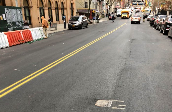 DOT has repainted a centerline -- but no bike lanes -- on a recently repaved segment of East Broadway. Photo: Noel Hidalgo