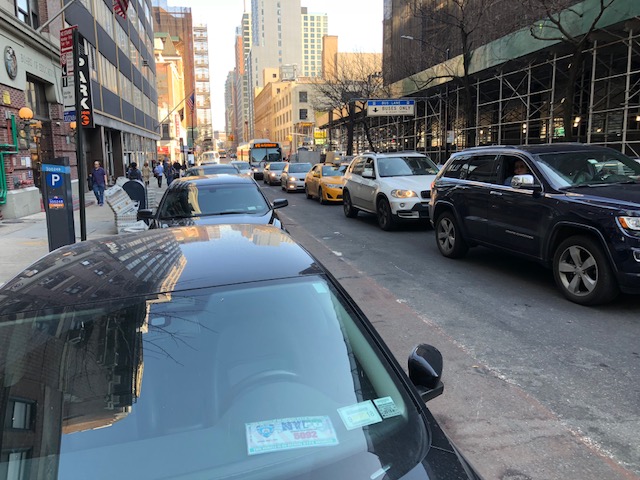The B41 in downtown Brooklyn can't use the bus lane thanks to chronic placard abuse, so riders sit in traffic instead. Photo: Ben Fried