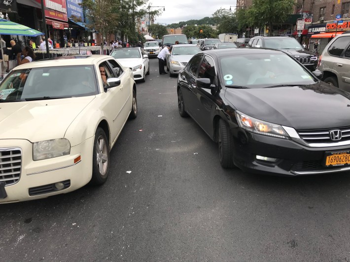 As the mayor decides what he wants to do with the Dyckman Street bike lane, it has reverted to a double-parking zone. Photo: Ben Jay