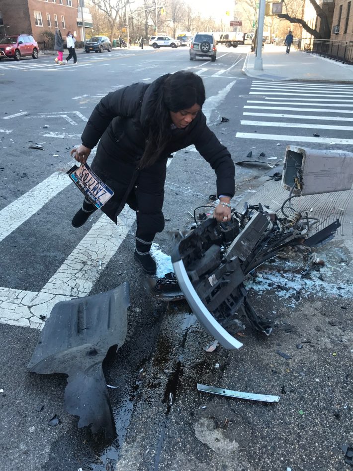 A woman who declined to give her name sifted through the debris to get her license plate. Photo: David Weiner
