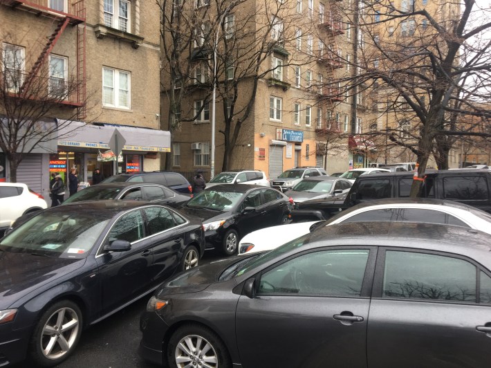 Cops just park wherever they want. These vehicles are all flashing NYPD placards. Photo: Ben Verde